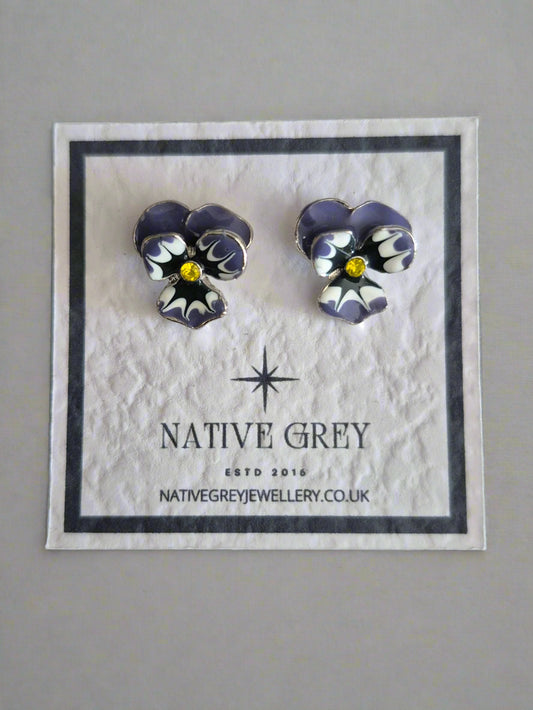 Pair of earrings on a Native Grey branded card against a gray background