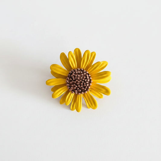 Yellow flower-shaped object on a gray background