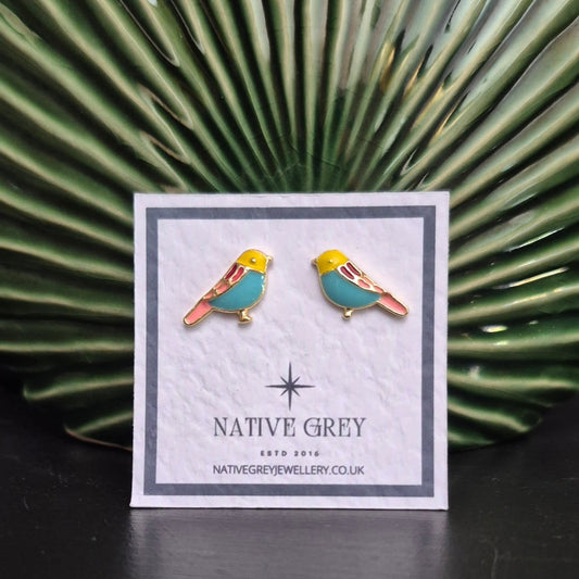Bird-shaped earrings on a Native Grey branded card with a green leafy background