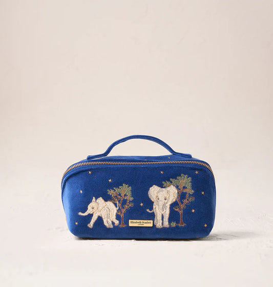 Blue cosmetic bag with elephant designs on a beige background
